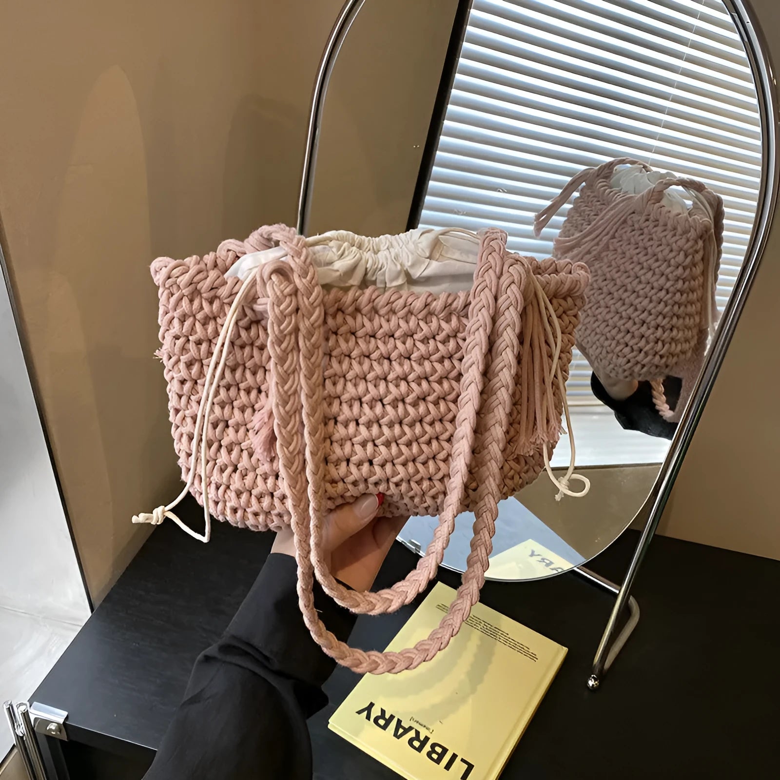 Knitted bucket shoulder bag in beige with external sandwich pocket and sewing thread detail for women