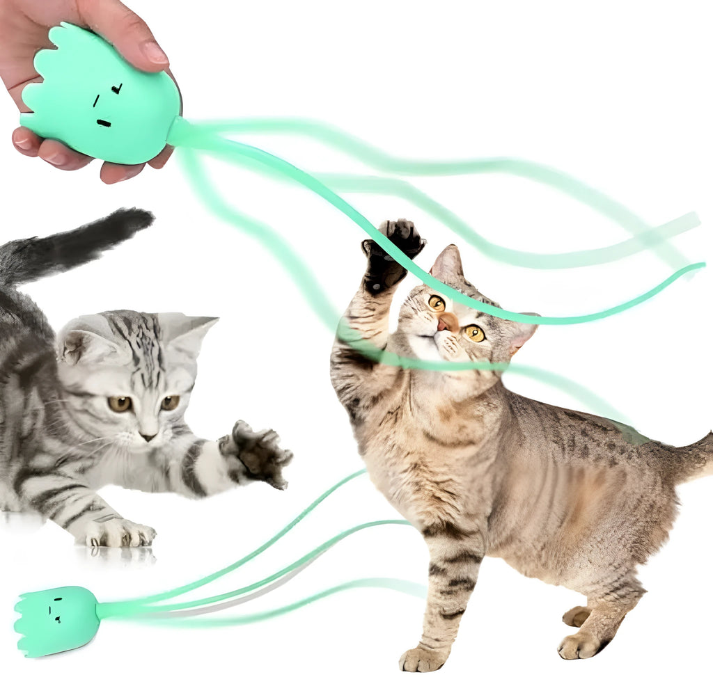 Green automatic cat wand toy with swinging silicone tail on floor for indoor cat play