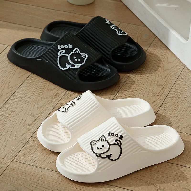 Green cat slippers with a thick EVA platform and non-slip sole on a wooden floor.