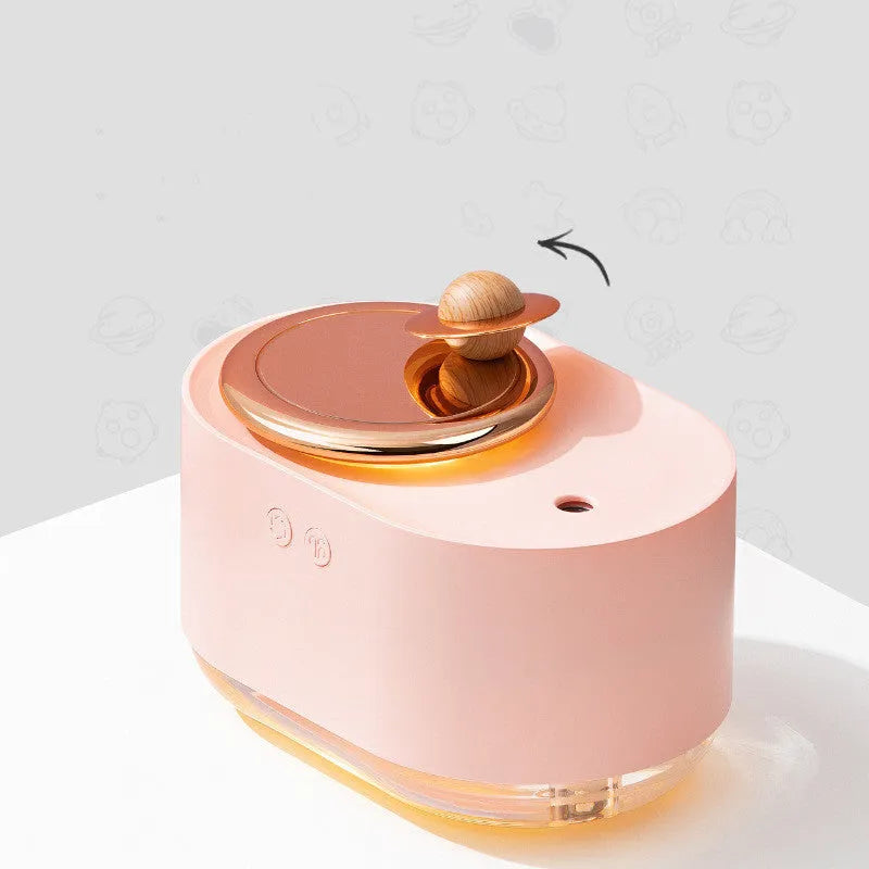 Rotating planet-shaped USB car humidifier in white with night light on, showing compact size.