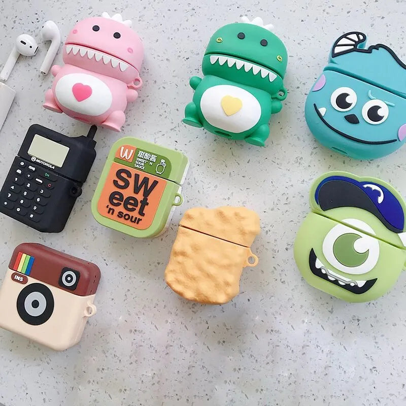 Silicone AirPod case with cartoon animal design in multiple colour options on a table.