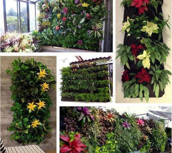 Vertical green felt wall hanging planter with multiple pockets full of herbs and flowers