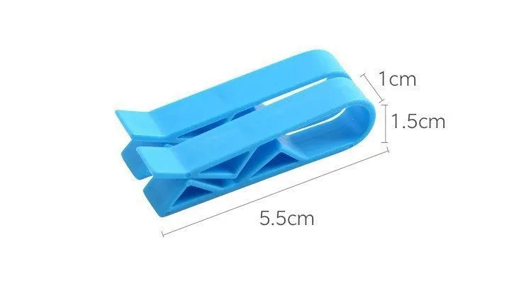 White PP plastic garbage bag fixing clip attached to the rim of a black indoor bin.