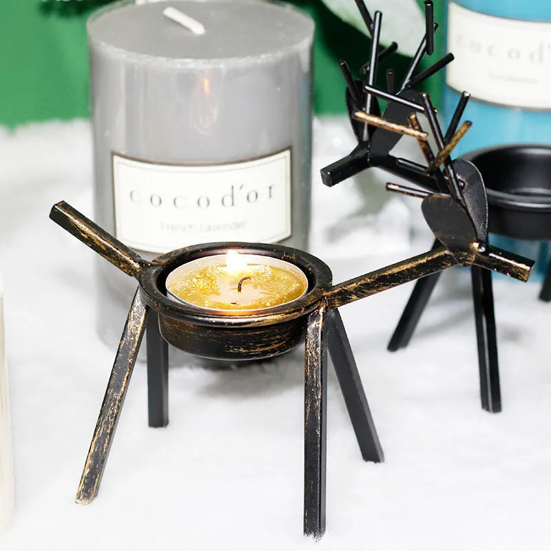 Black iron Christmas deer candlestick holder with elk bracket and festive motifs.