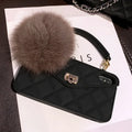 Plush hairball texture TPU back cover case for iPhone on a dark green grid background.