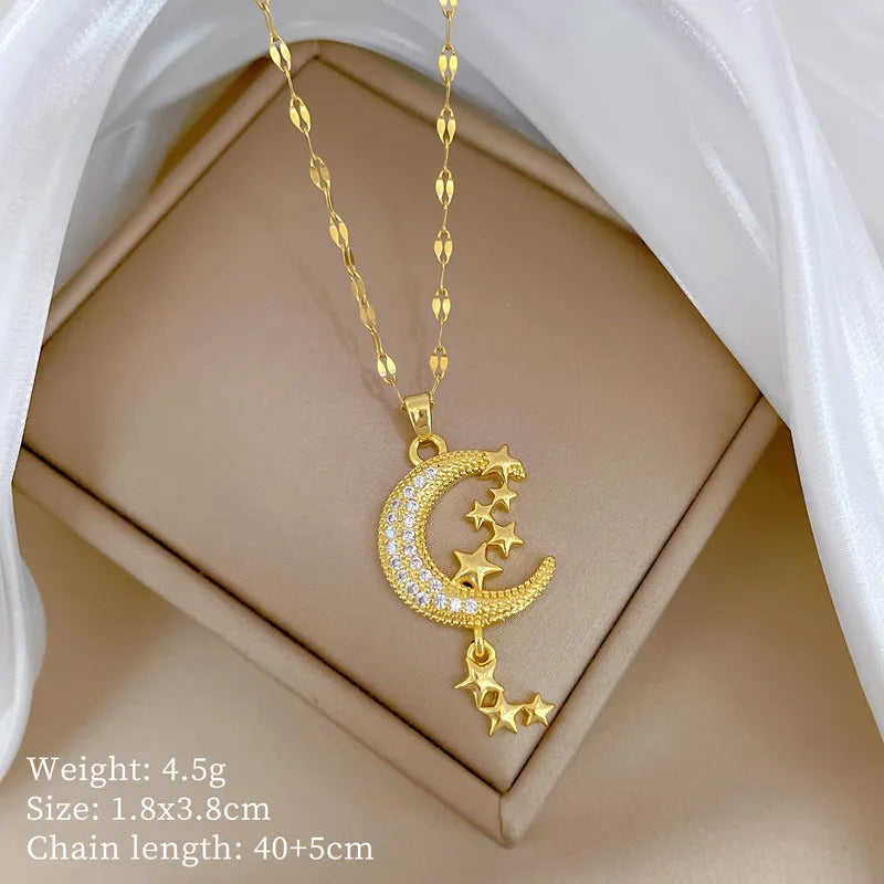 Moon pendant necklace with diamond accents and tassel on stainless steel chain