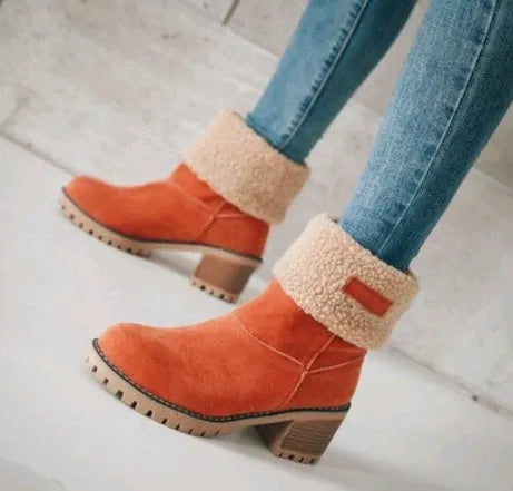 Women's black suede mid-tube snow boots with a round toe and thick low heel on a waterproof platform.