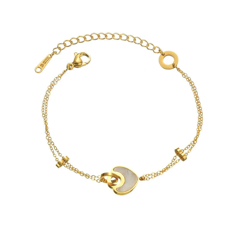 Women's stainless steel bracelet with double-layer design and a hanging heart charm in a resin-like electroplated finish.