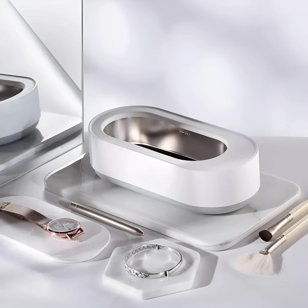 White portable ultrasonic cleaner with digital display and stainless steel cleaning tank.