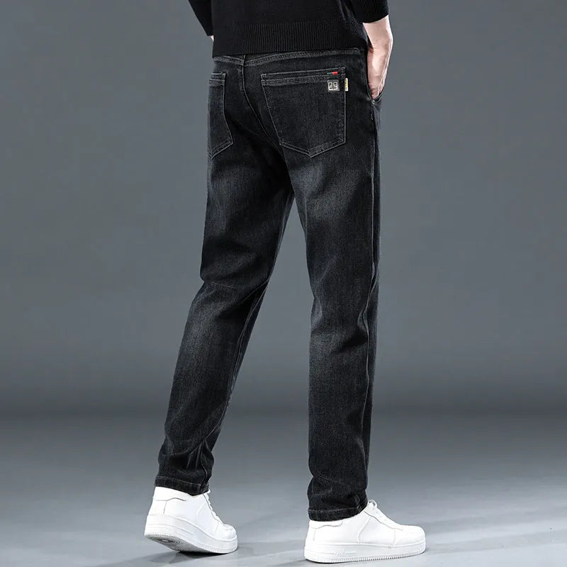Blue grey slim straight casual trousers with a mid waist and zip fly on a neutral background.