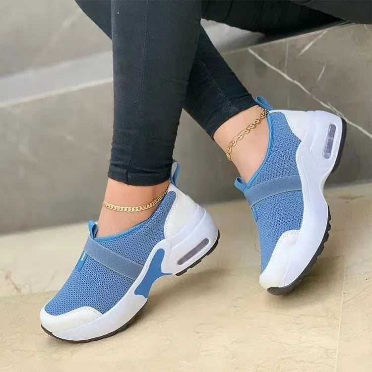 Women's flat mesh sneakers in multiple colours with a round toe and rubber sole.