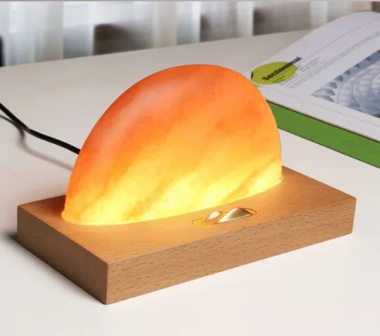Sunrise Oriental wooden base table lamp with natural salt block shade and integrated wireless phone charging pad.