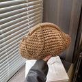Shell-shaped straw shoulder bag with chain detailing and internal zipper pocket