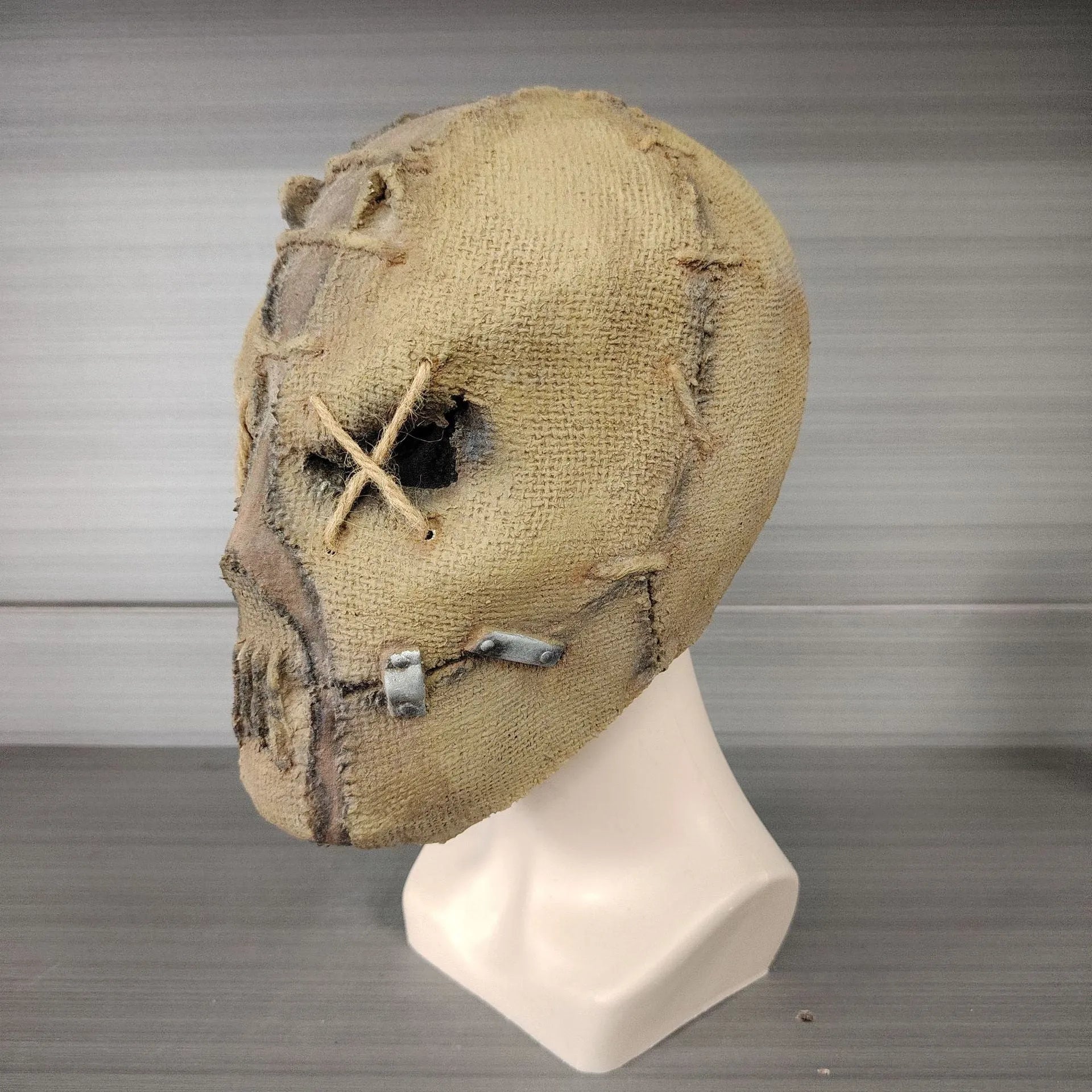Latex horror mask with scar skull design worn as a full head cover for Halloween costumes