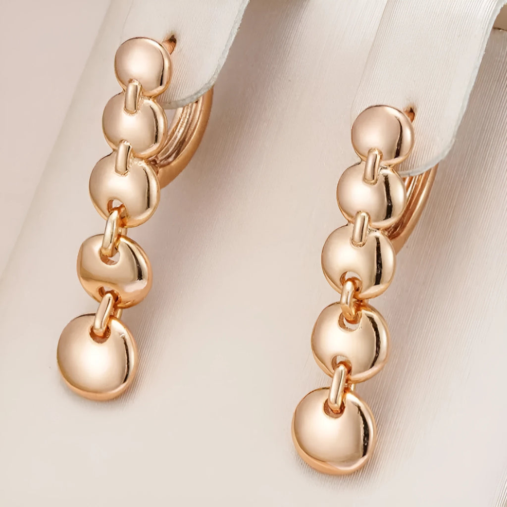 Long gold retro hoop earrings with woven copper texture, shown as a pair.