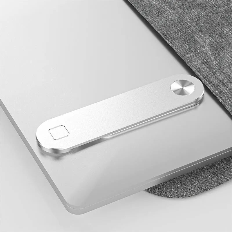 Black aluminium laptop phone holder with magnetic clip attached to a laptop screen, holding a smartphone.