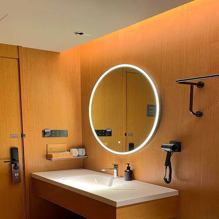 Round black aluminium frame LED smart bathroom mirror on wall with touch control for light colour and dimming.