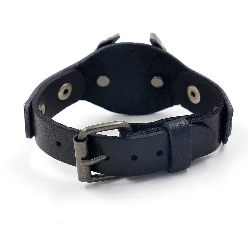 Black geometric leather bracelet with a detailed alloy eagle watch-button clasp on a wrist.