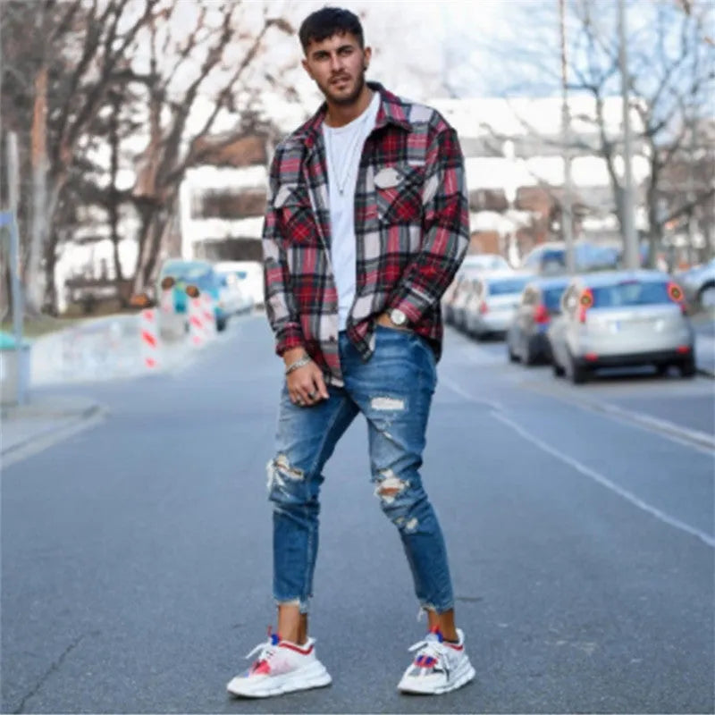 Men's deep blue cotton jeans with distressed hole details on the legs