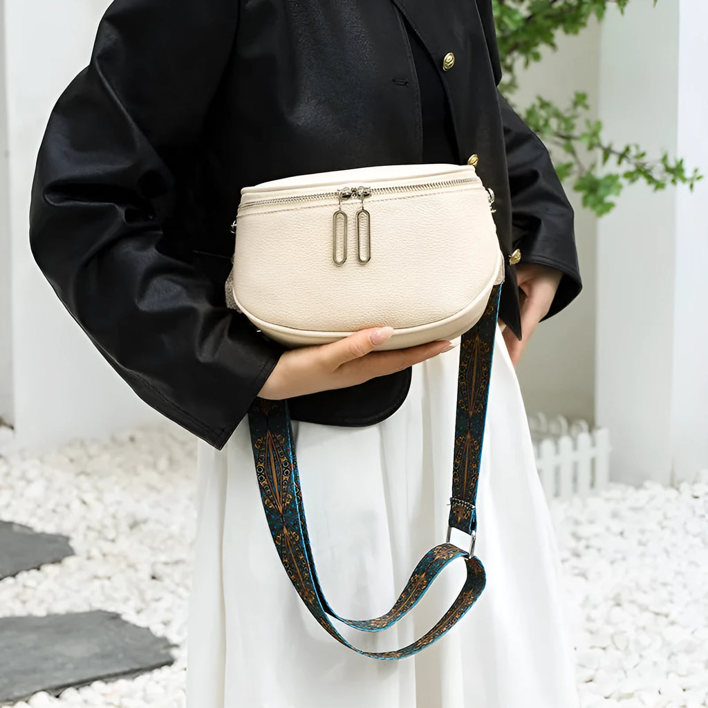 A soft black PU leather women's messenger bag with a saddle shape and cross-body strap on a white background.