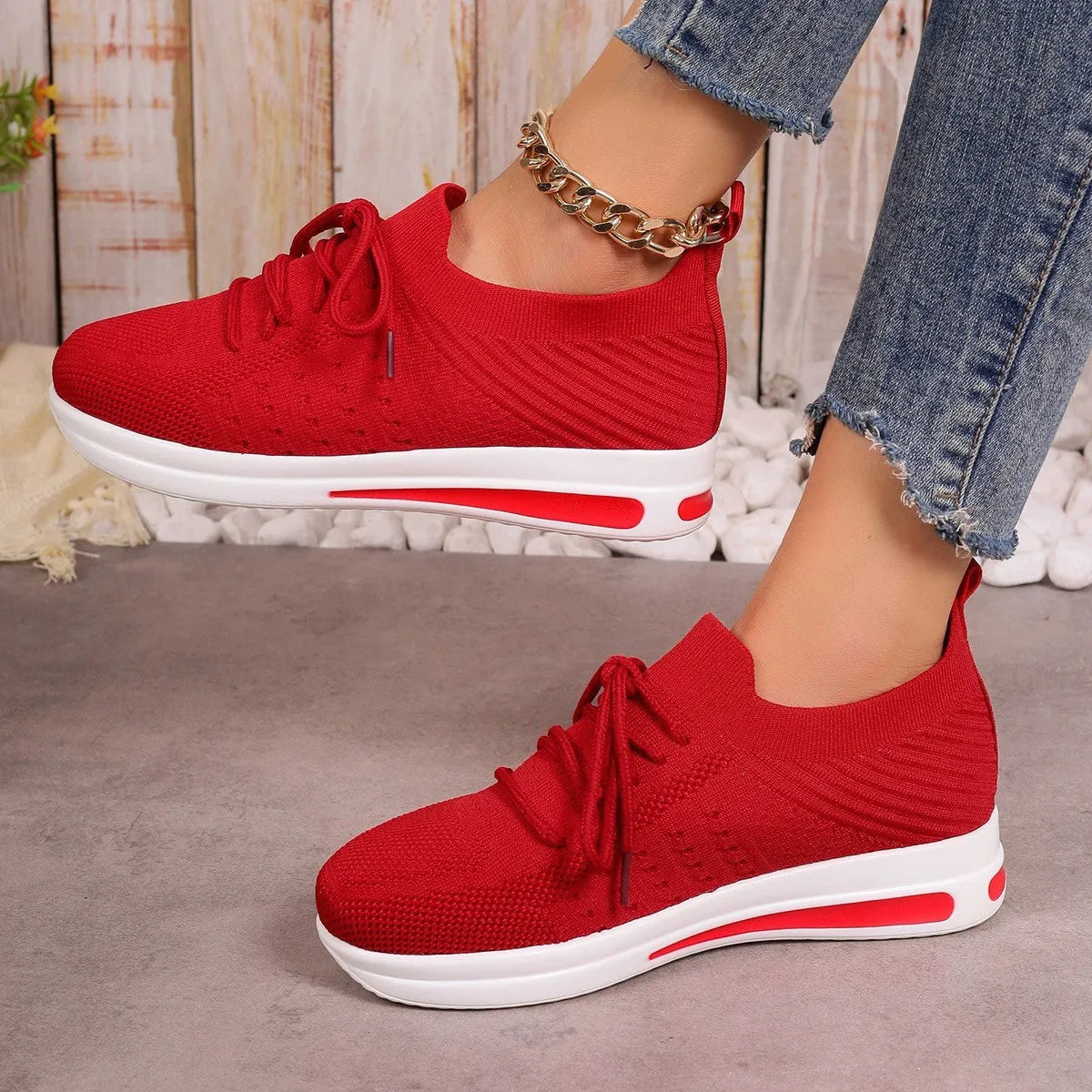 Women's red fly-knit casual sneakers with round toe and lace-up front on a white background