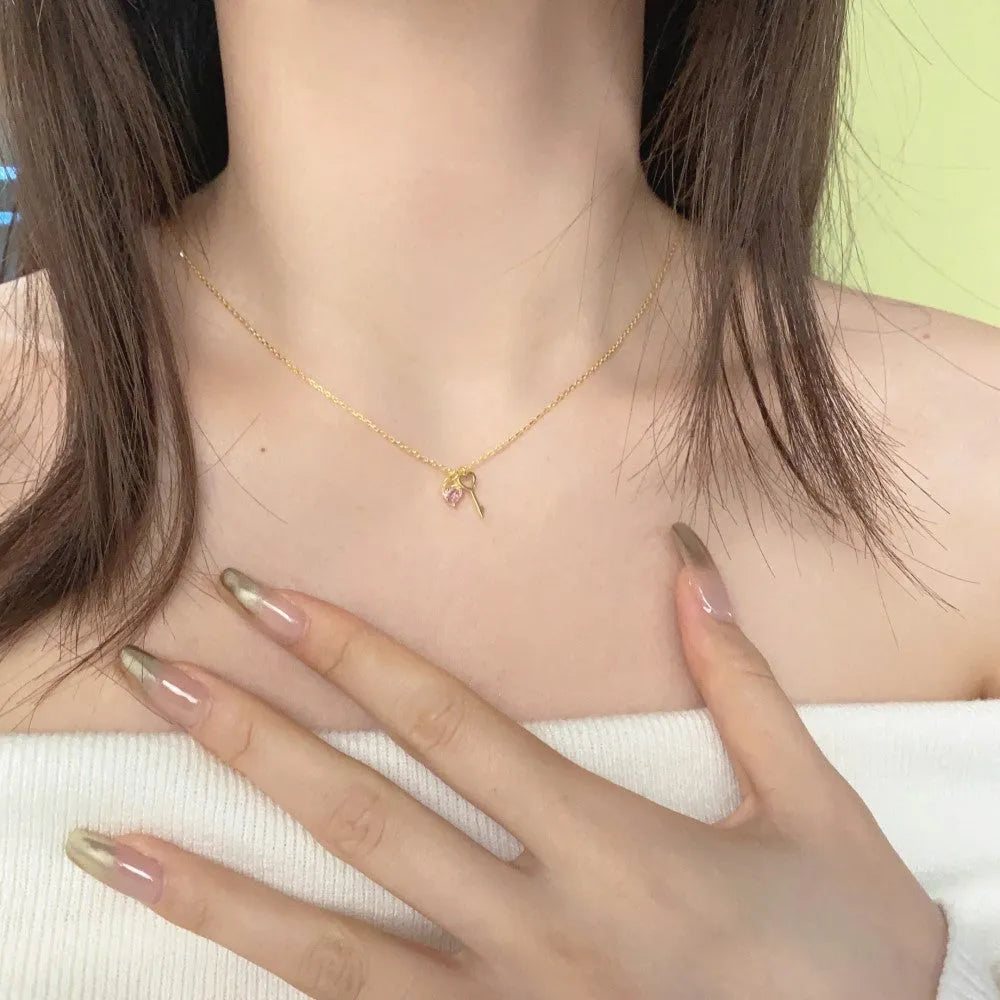 925 sterling silver heart-shaped key pendant necklace in gold finish on display