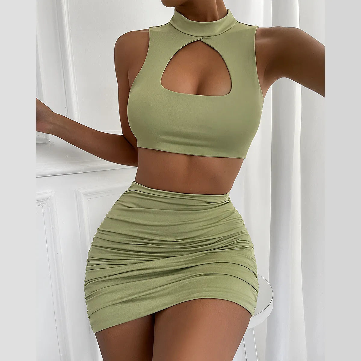 Light purple women's two-piece set with hollow vest top and matching hip skirt