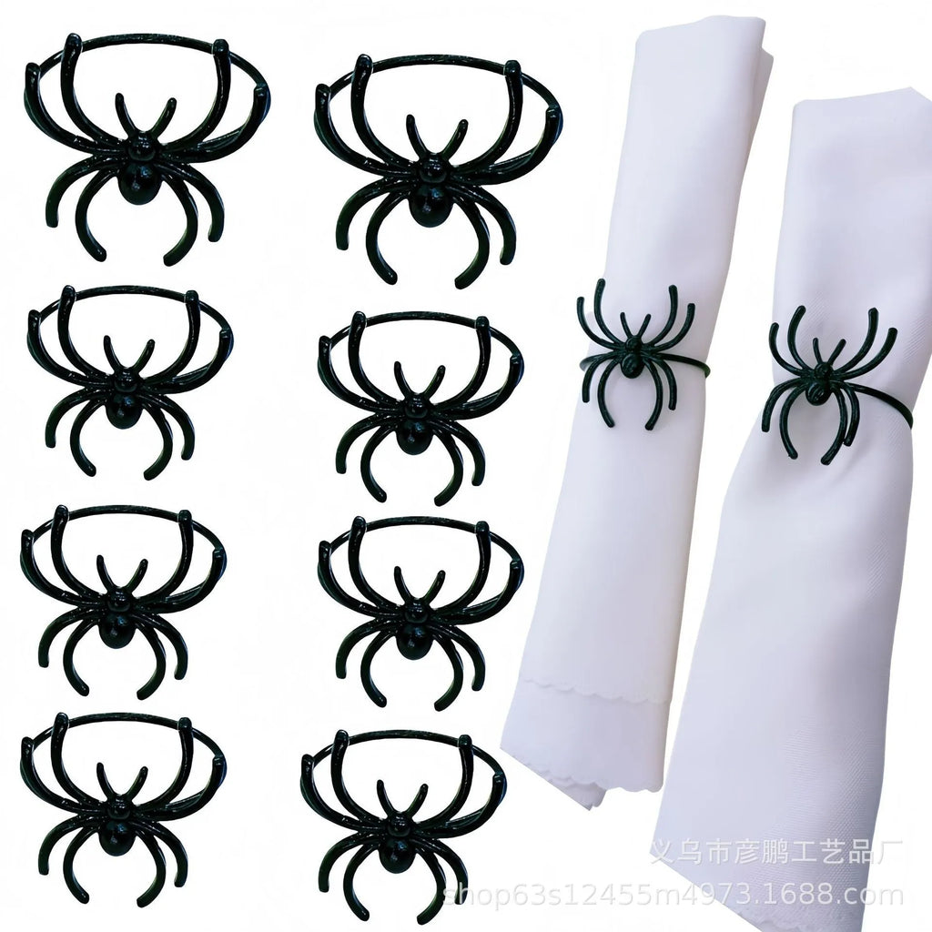 Six black alloy spider-shaped napkin rings for Halloween table settings.