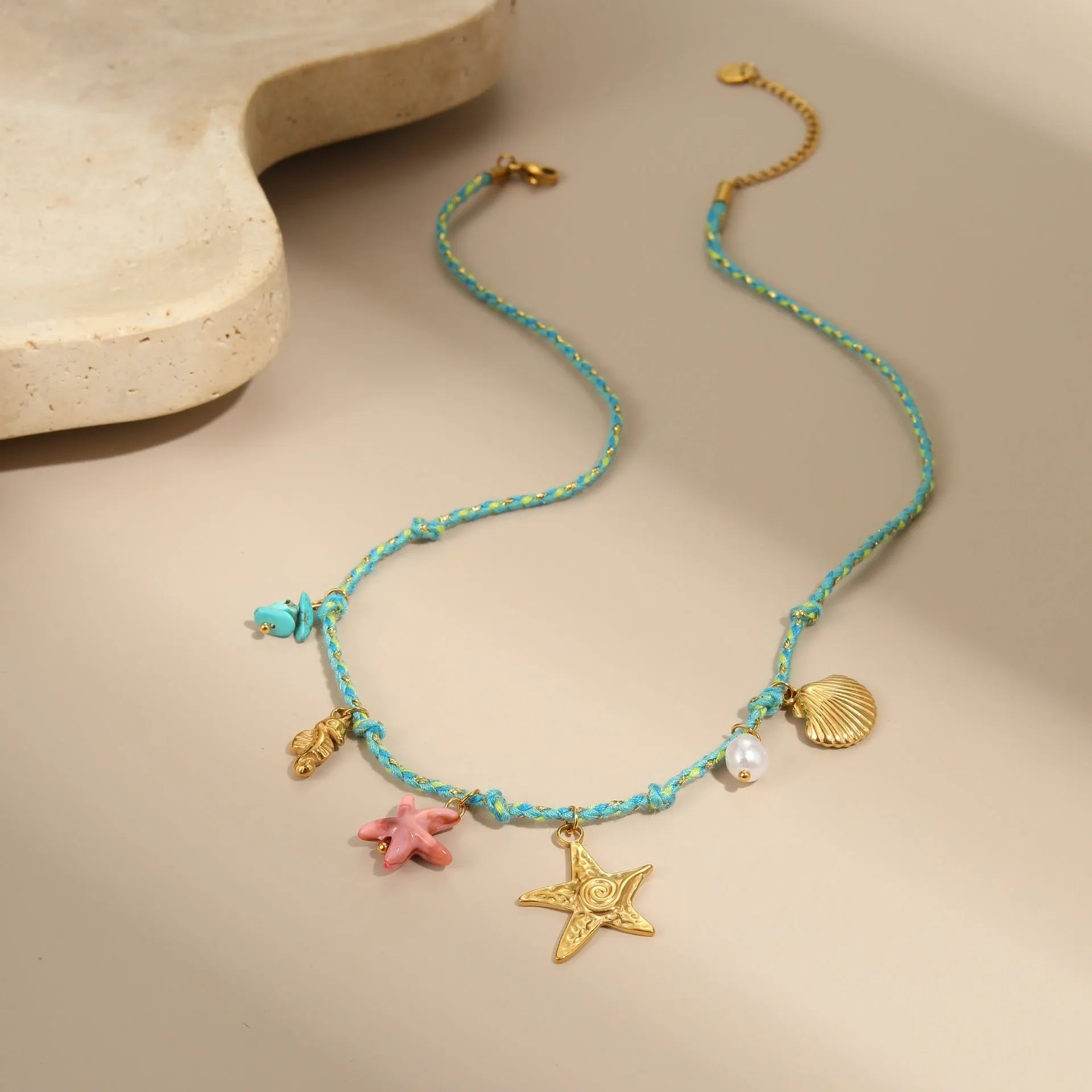 Handmade colour braided rope and stainless steel necklace with heart-shaped pendant on adjustable chain.