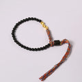 Hand-woven obsidian bracelet with dark beads showing woven texture and adjustable 15.5-16cm length