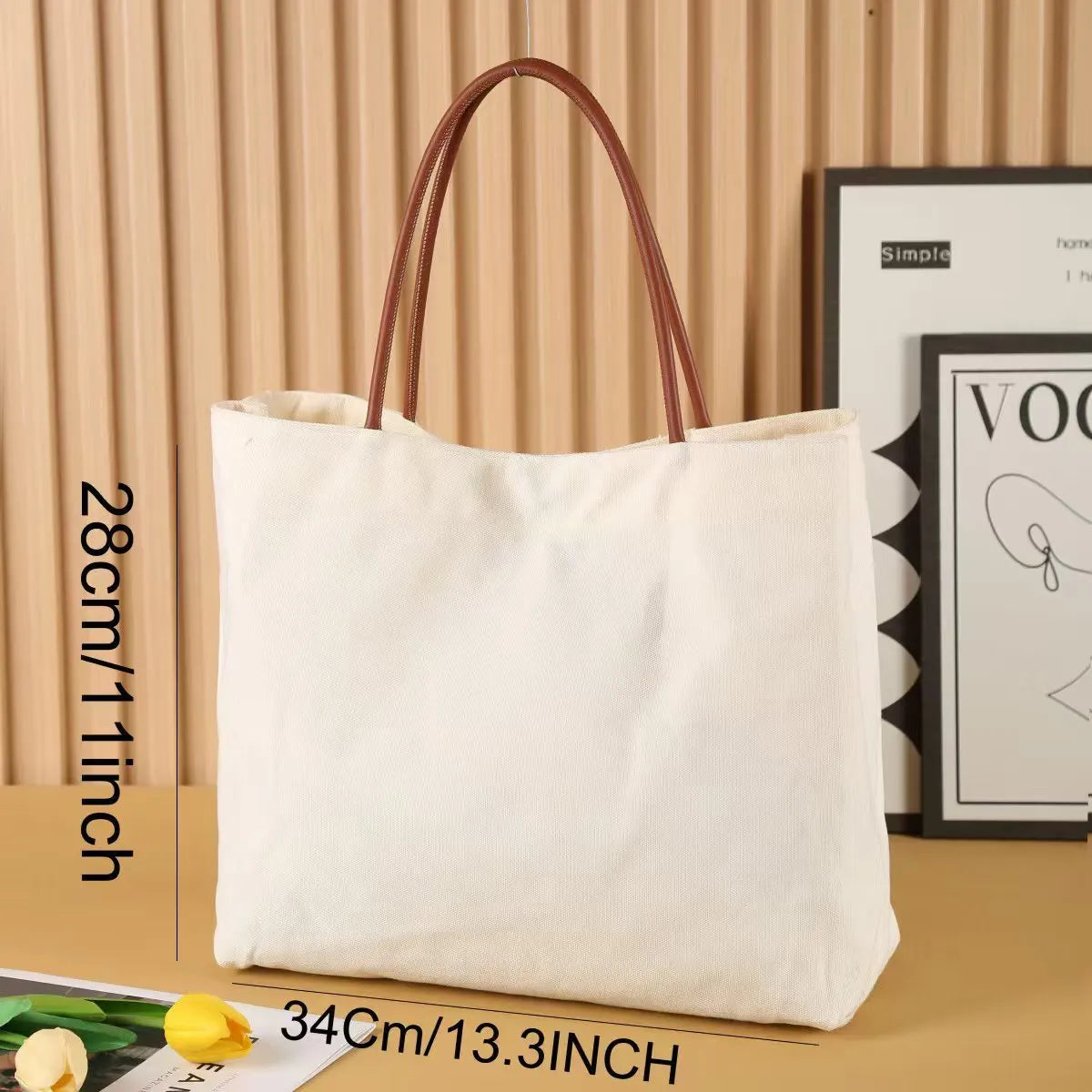 Beige white canvas tote bag with cotton handles, showing interior patch pocket and exterior zipper pocket.