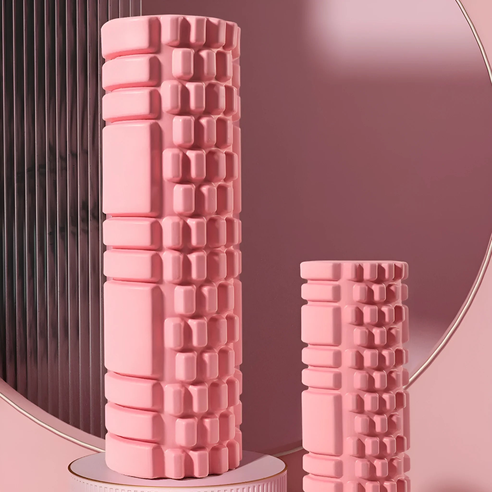 A cylindrical EVA foam roller for fitness recovery, shown in a choice of colours including pink, blue, and grey.