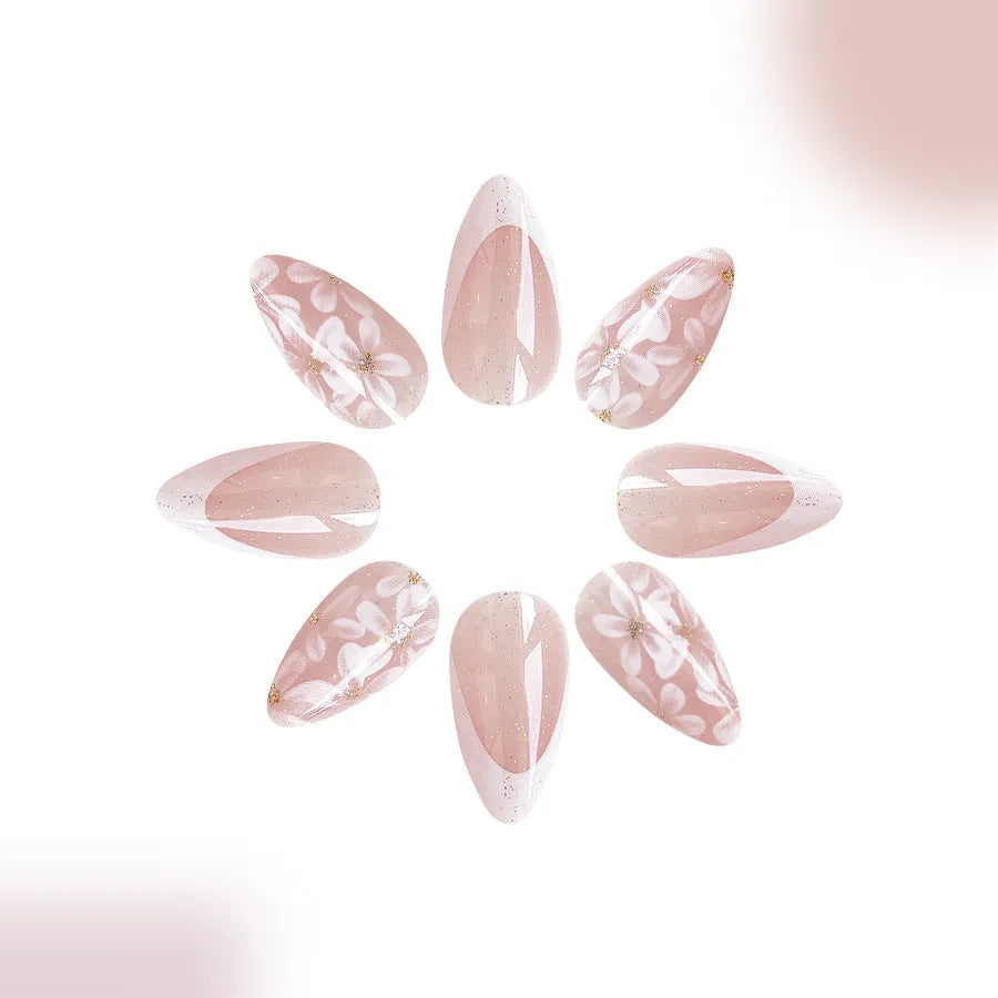 Short almond French manicure press-on nails with pink glitter finish and floral designs