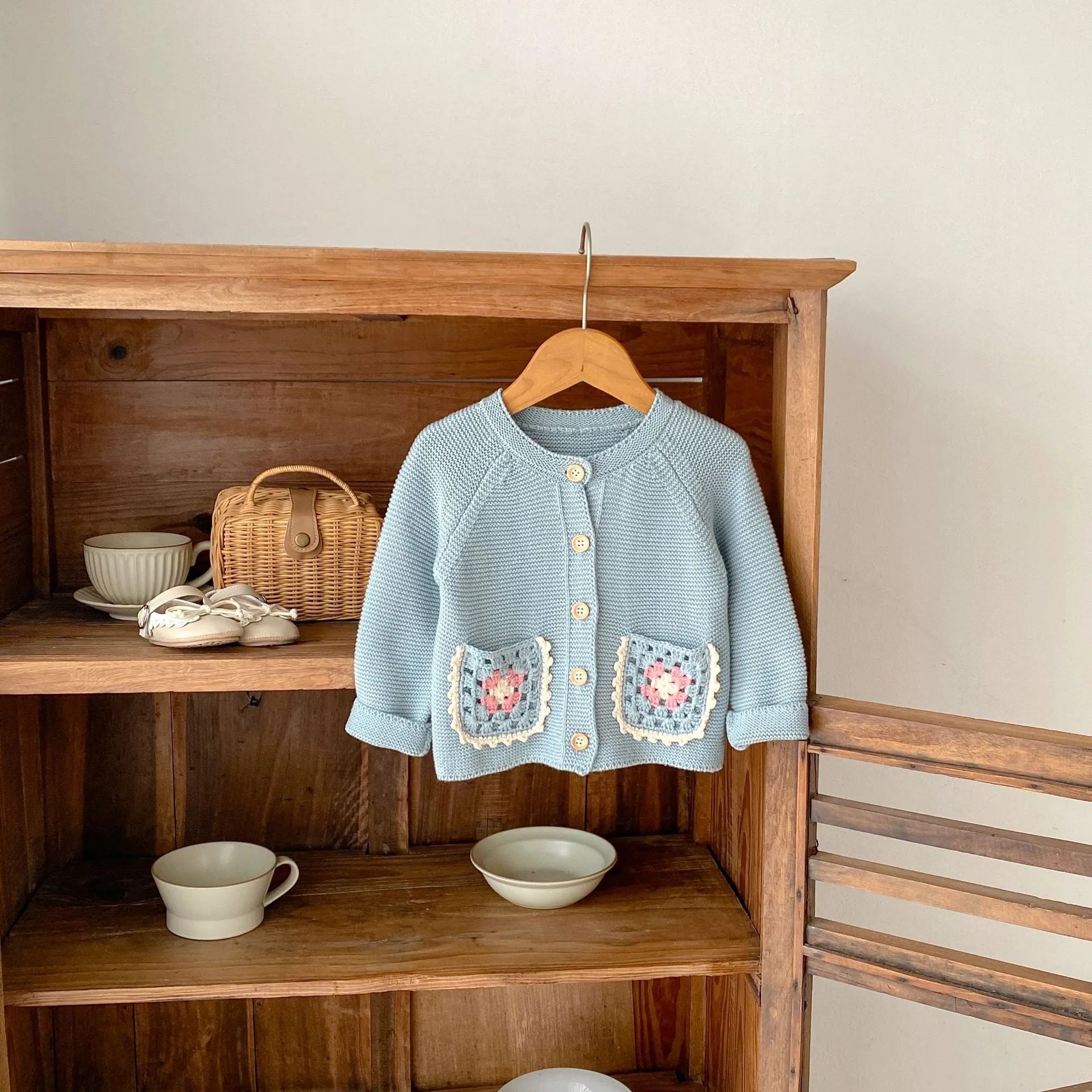 Children's hand crochet cotton cardigan in smokey blue with round collar and hollow flower pocket