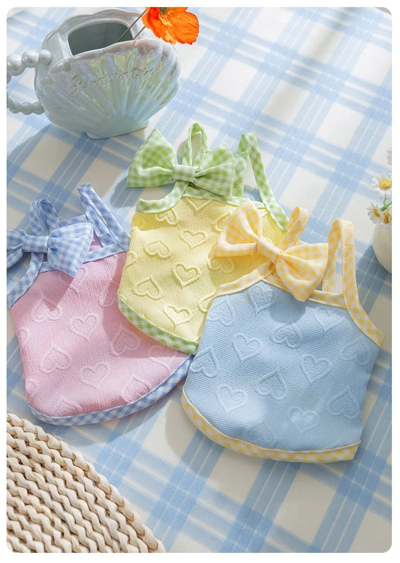 Small dog wearing elastic suspenders vest with heart relief bow in Bondi Blue colour