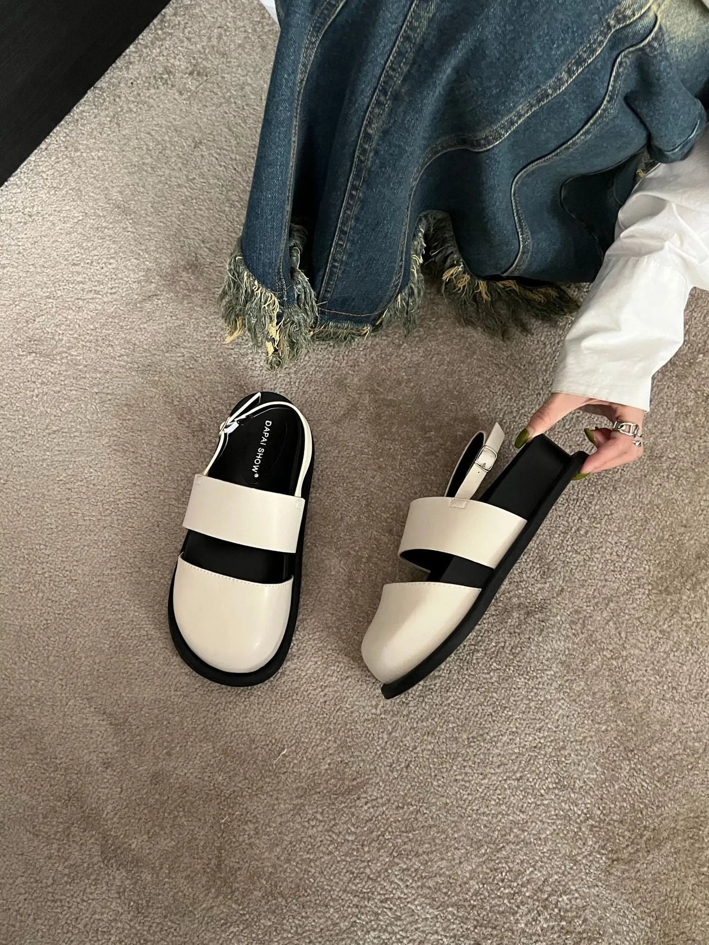 Retro closed toe sandals with an ankle buckle in apricot colour on a white background