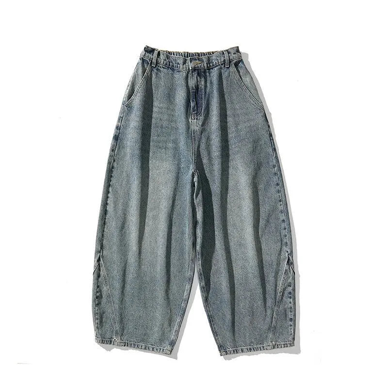 Men's plus-size baggy blue jeans with a wide leg and straight hem on a casual background.