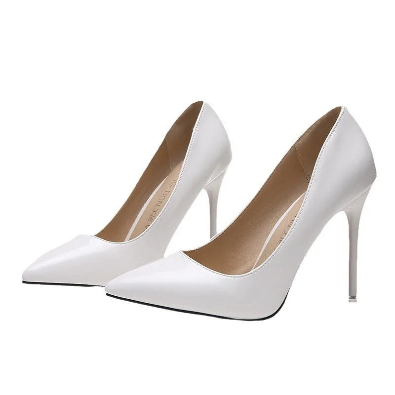 Women's nude apricot stiletto heel pumps with pointed toe and buckle detail on a chunky heel.
