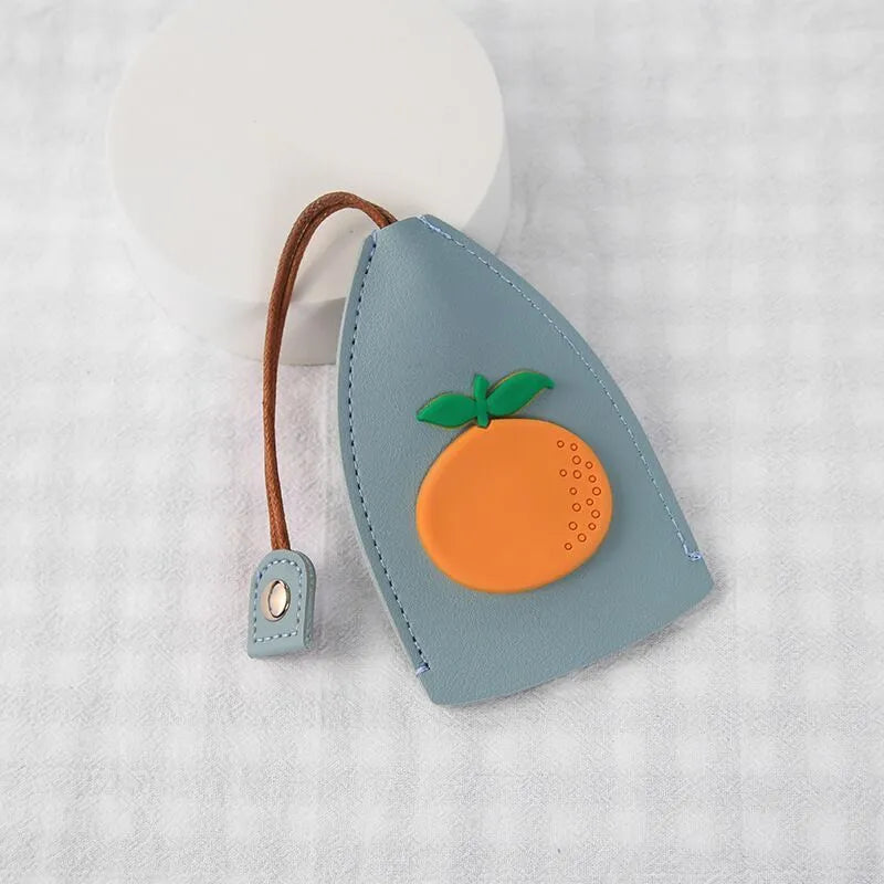 Colourful cartoon pull-out key protector case made from PU leather, showing a selection of fruit and animal designs.