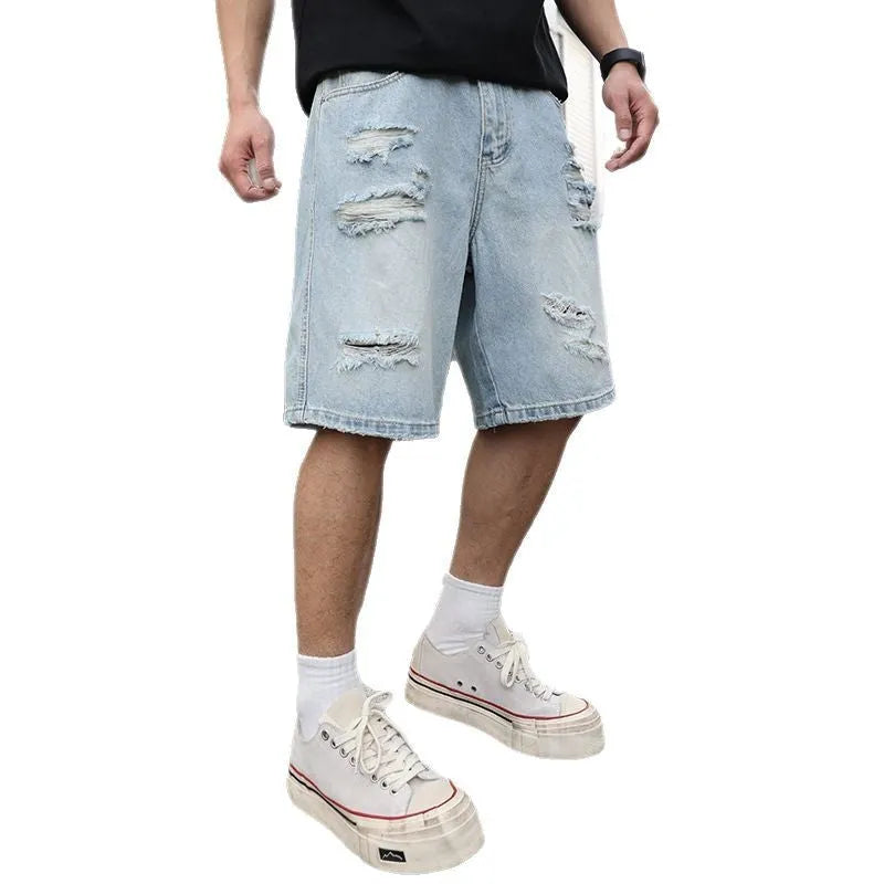 Light blue distressed denim shorts with ripped detailing and loose fit design