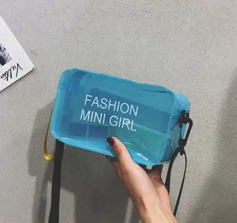 A transparent square jelly crossbody bag with a single adjustable shoulder strap.