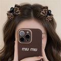 Pair of leopard bow plastic hair barrettes with Seiko finish in brown leopard pattern