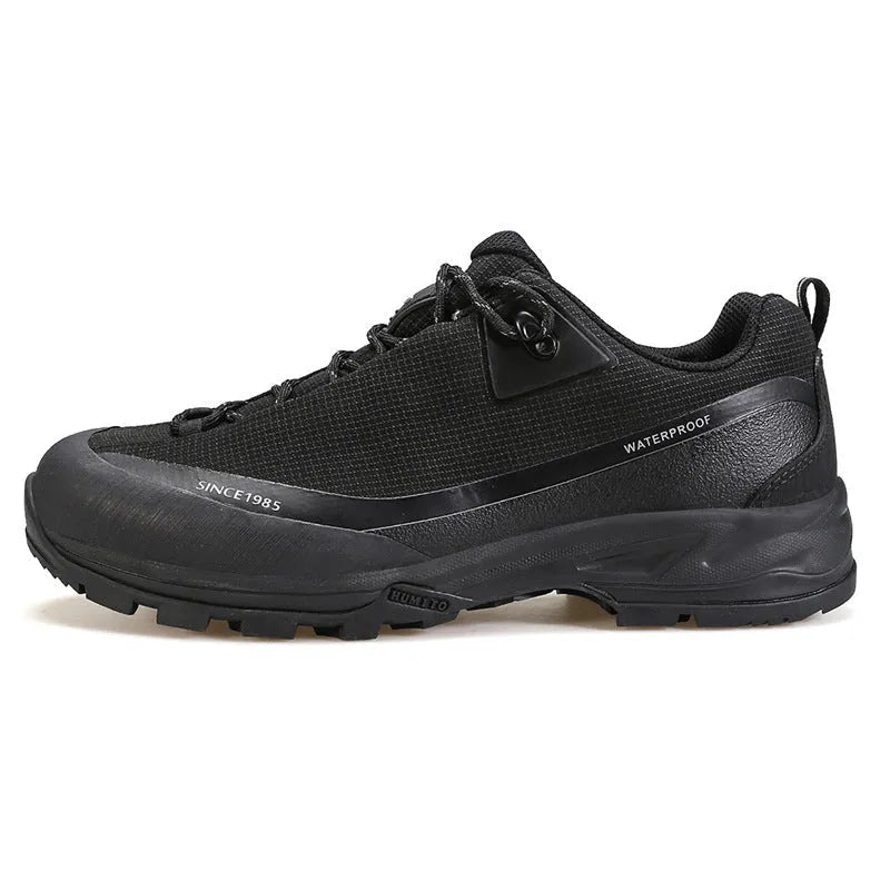 Men's low-top hiking boots in black with leather mesh upper and lace-up front.
