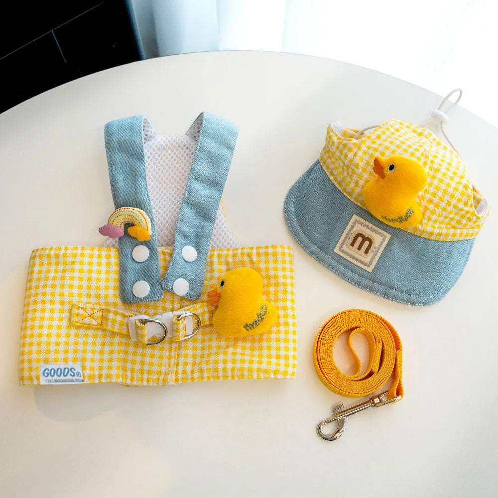 Pet dog harness and leash set with a cute animal hat and a blue tug rope on a green background.