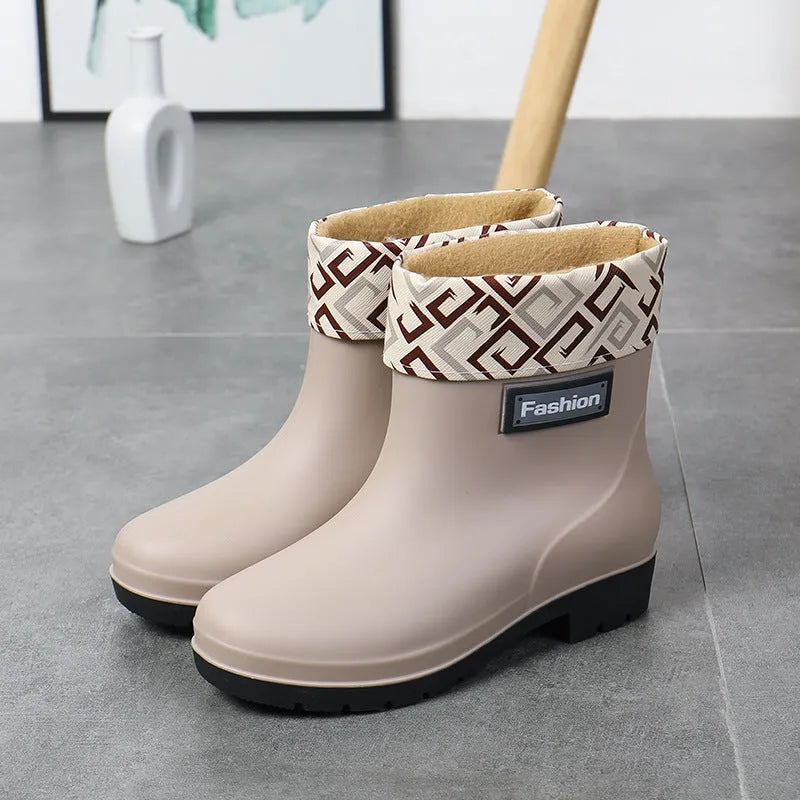 Women's PVC rain boots in black with mid-calf height and low heel design