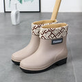 Women's PVC rain boots in black with mid-calf height and low heel design