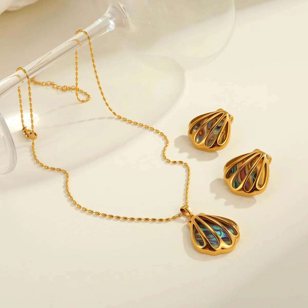 Gold plated stainless steel scallop shell stud earrings and necklace set with fan-shaped geometric design