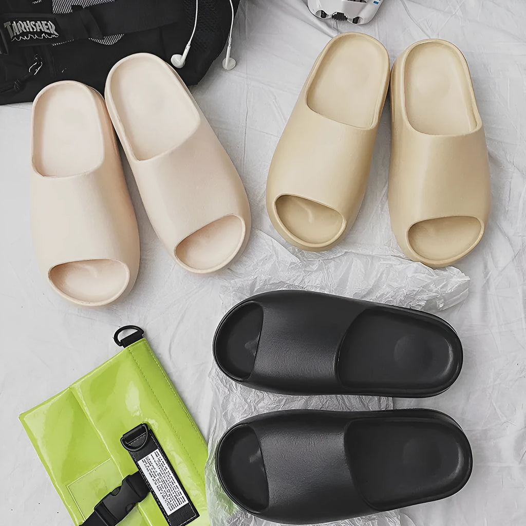 Women's thick-soled beach slippers in beige, black, brown, or green, showing EVA injection moulded construction.