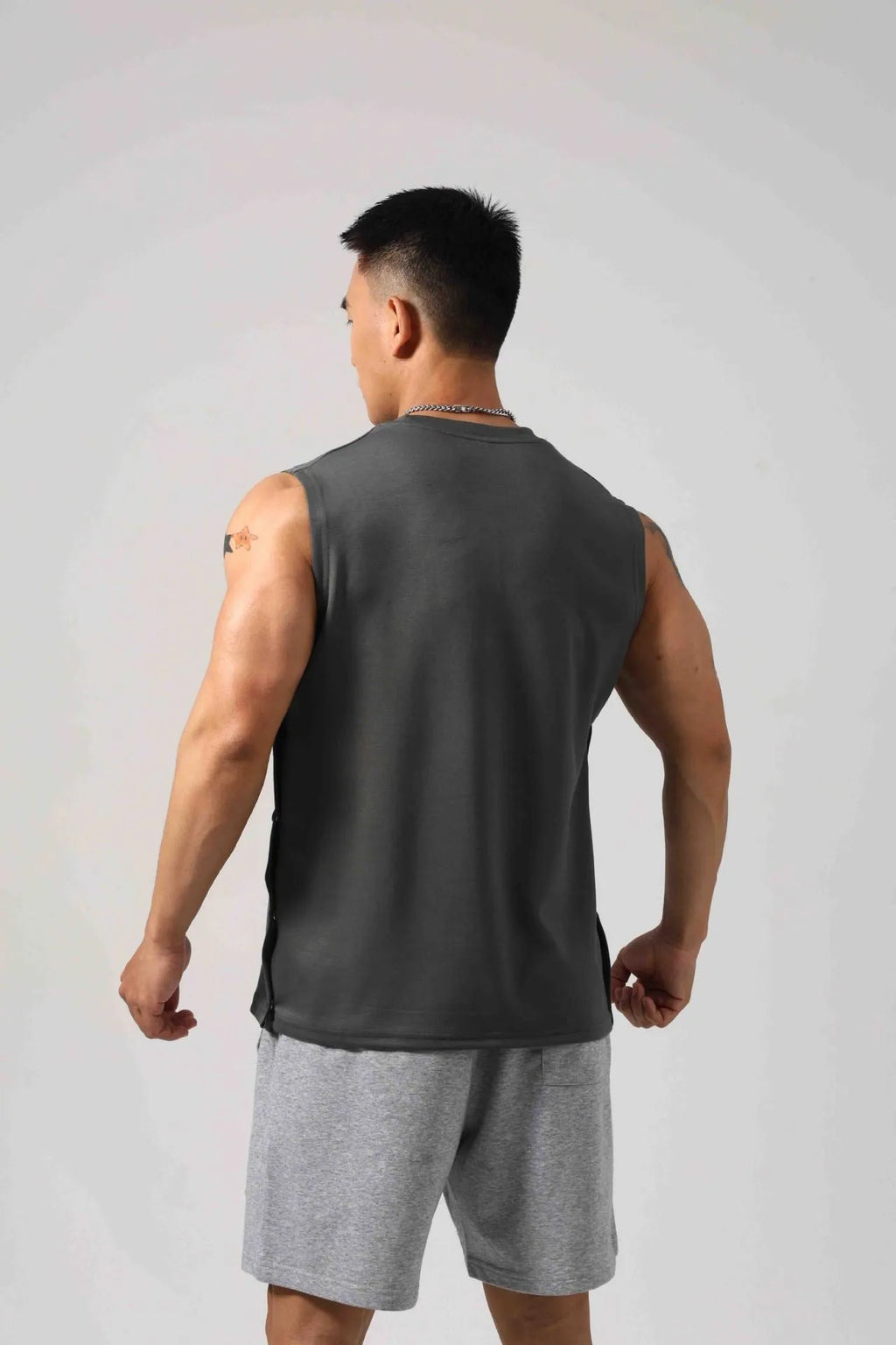 Korean style men's loose fit fitness vest with hidden hook side openings in solid cotton fabric