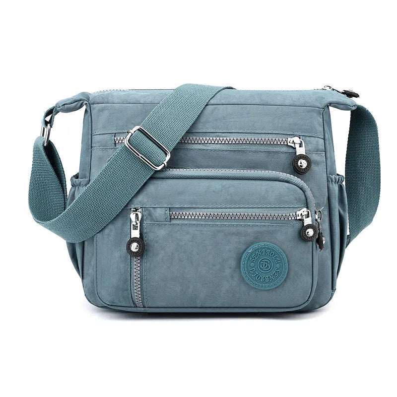 Nylon soft shoulder messenger bag in square vertical shape with single strap.